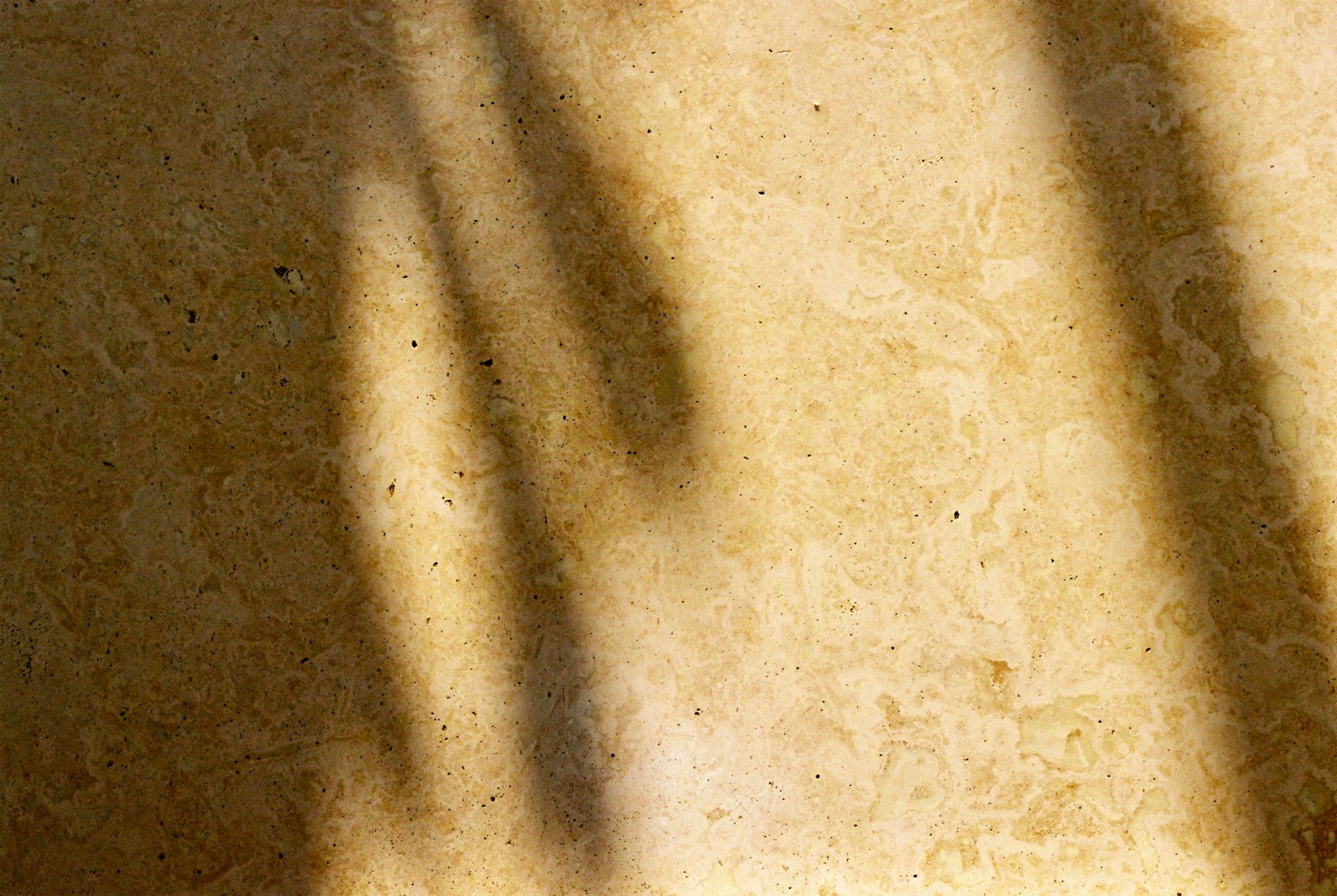 Cream stone floor with soft window shadows