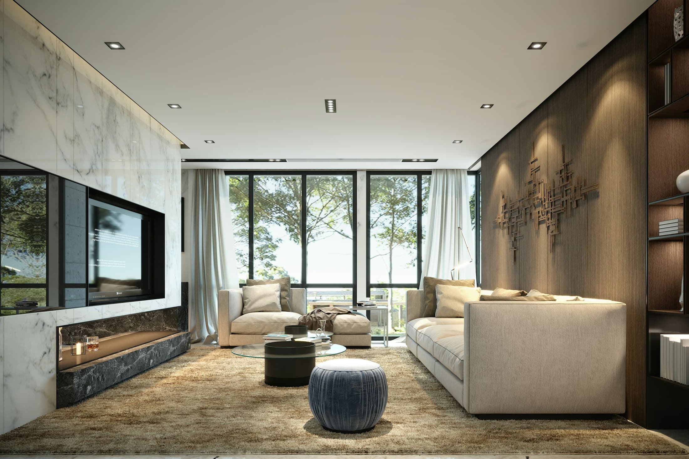 Living room with a stone feature wall, cream sofas and large windows facing a garden